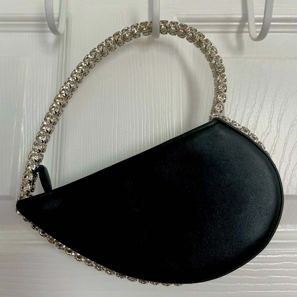 Small, black Akira, heart-shaped clutch.